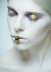 Image showing Bumblebee: model with creative make-up and bug on her lips