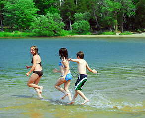 Image showing Children running into water