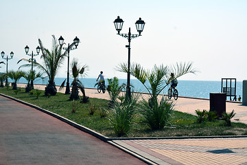 Image showing Promenade next to the sea and people on the bicycles