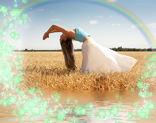 Image showing stretching woman with rainbow, water and flowers