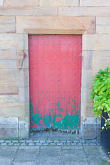 Image showing Very rustic green and red door