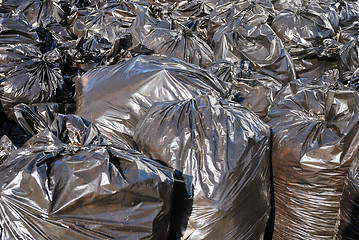 Image showing pile of black garbage bags with tons of trash, horizontal