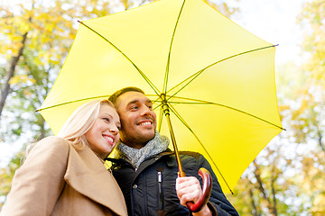 Image showing smiling couple hugging in autumn park