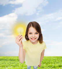 Image showing smiling little girl holding light bulb