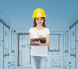 Image showing smiling little girl in hardhat with clipboard