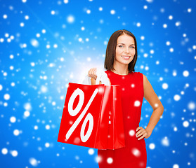 Image showing woman in red dress with shopping bags