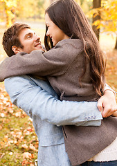 Image showing smiling couple hugging in autumn park