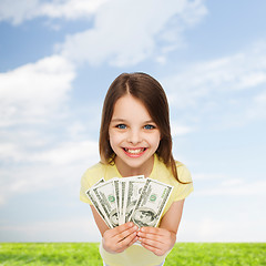 Image showing smiling little girl with dollar cash money