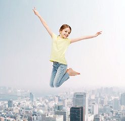 Image showing smiling little girl jumping