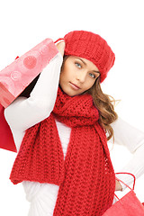 Image showing smiling woman in winter clothes with shopping bags