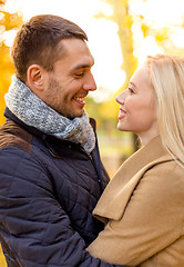 Image showing smiling couple hugging in autumn park