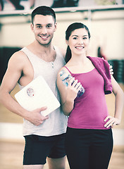 Image showing two smiling people with scale in the gym