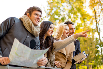 Image showing group of friends with map outdoors