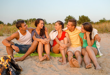 Image showing smiling friends in sunglasses on summer beach