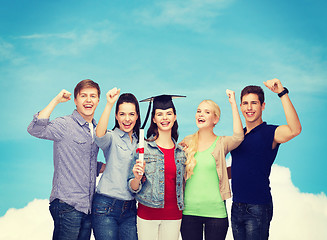 Image showing group of standing smiling students with diploma