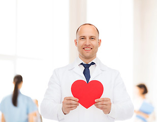 Image showing smiling male doctor with red heart