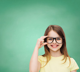 Image showing smiling cute little girl in black eyeglasses