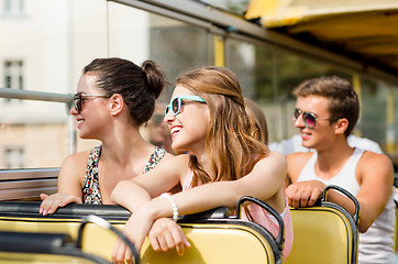 Image showing group of smiling friends traveling by tour bus