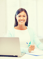 Image showing asian businesswoman with laptop and documents