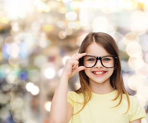 Image showing smiling cute little girl in black eyeglasses