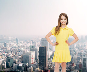 Image showing smiling little girl in yellow dress