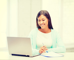 Image showing asian businesswoman with laptop and documents