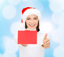 Image showing woman in santa helper hat with blank red card