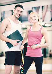 Image showing two smiling people with clipboard and measure tape