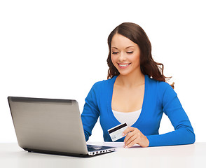 Image showing happy woman with laptop computer and credit card