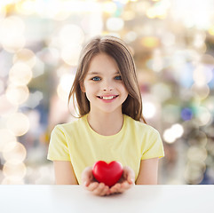 Image showing beautiful little girl sitting at table