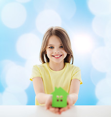 Image showing beautiful little girl holding paper house cutout
