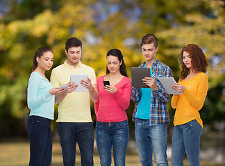 Image showing group of teenagers with smartphones and tablet pc