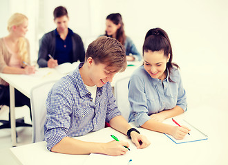 Image showing smiling students with notebooks at school