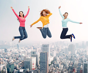 Image showing group of smiling women jumping in air