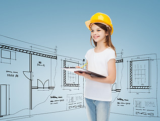 Image showing smiling little girl in hardhat with clipboard