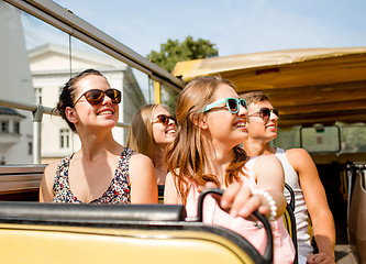 Image showing group of smiling friends traveling by tour bus