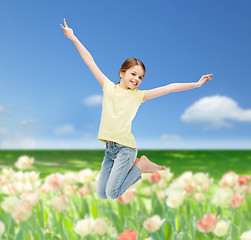 Image showing smiling little girl jumping