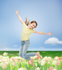 Image showing smiling little girl jumping