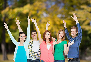 Image showing group of smiling students waving hands