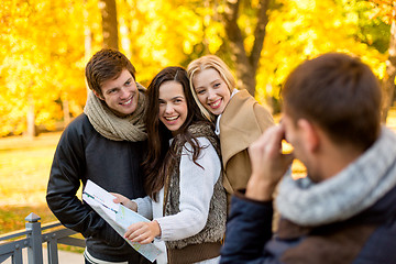 Image showing group of friends with map outdoors