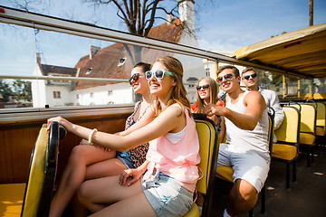 Image showing group of smiling friends traveling by tour bus