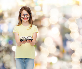 Image showing smiling cute little girl in black eyeglasses