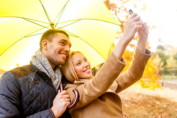 Image showing smiling couple hugging in autumn park