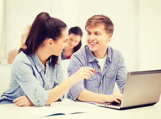 Image showing two smiling students with laptop computer