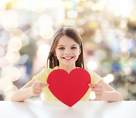 Image showing beautiful little girl sitting at table