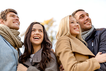 Image showing group of smiling men and women in autumn park