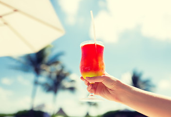 Image showing close-up of hand holding glass with cocktail