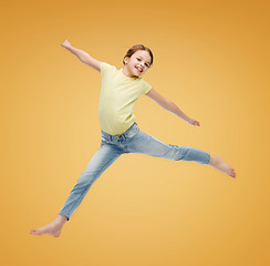 Image showing smiling little girl jumping