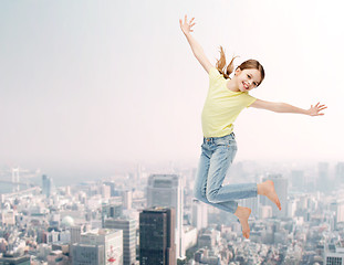 Image showing smiling little girl jumping