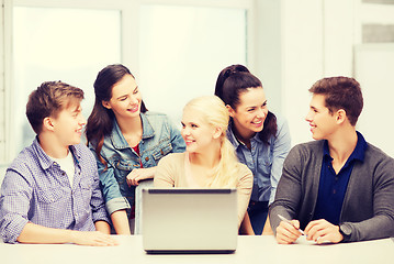 Image showing smiling students with laptop at school